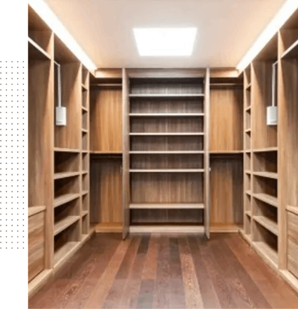 An empty walk in closet with wooden shelves