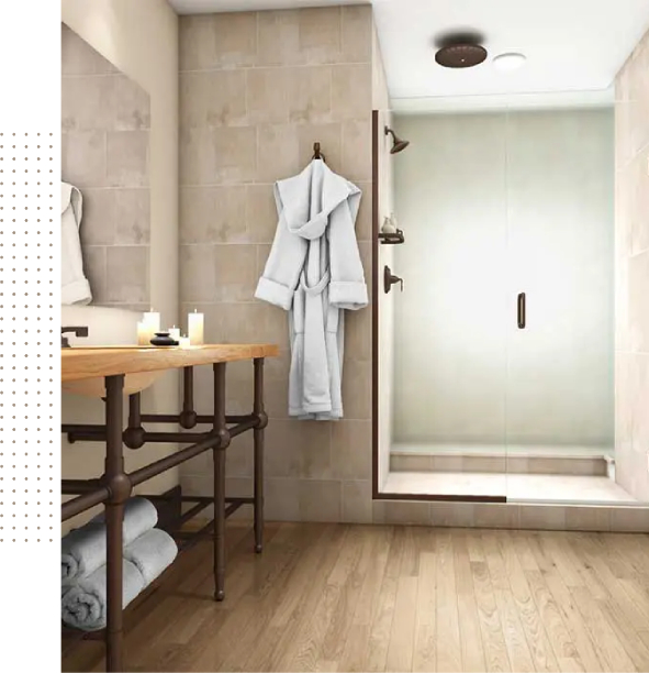 A bathroom with a shower, sink, and towel rack